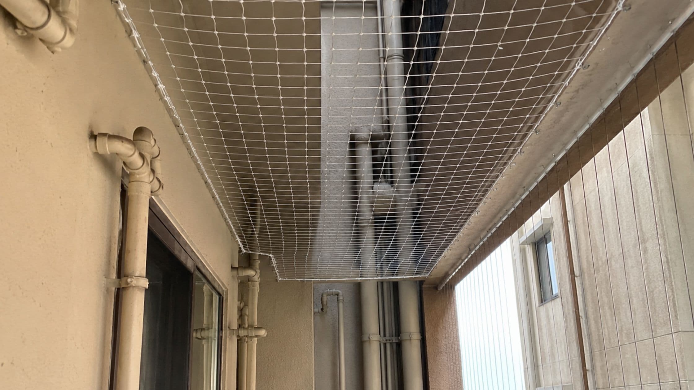 Safety net installed across a residential duct and utility shaft area