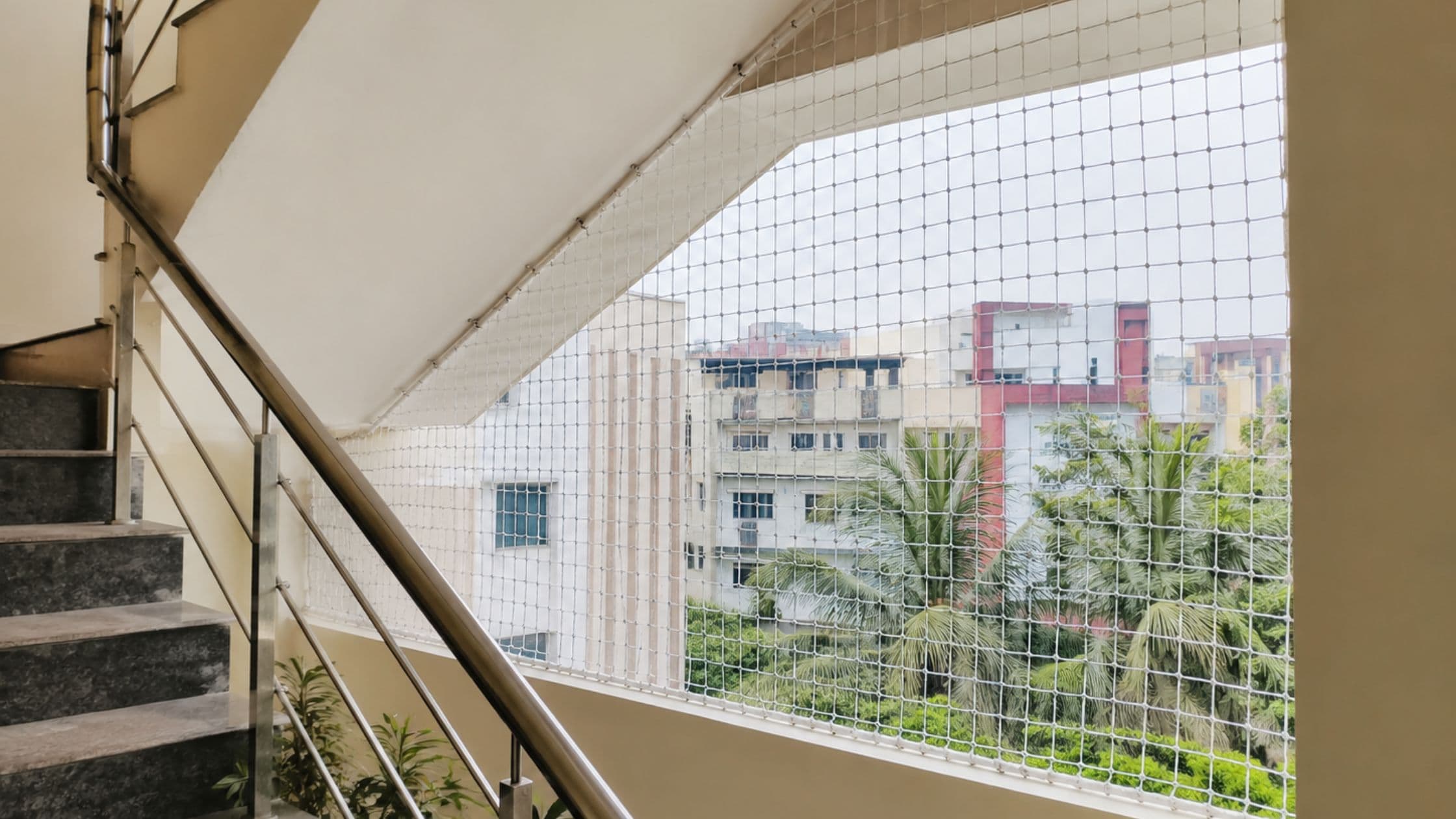 Safety net installed along an apartment stairwell opening
