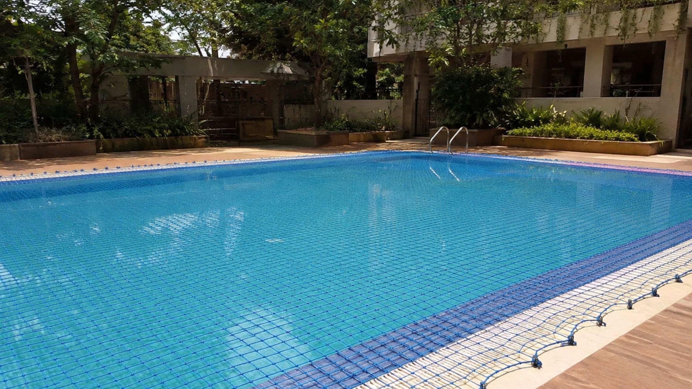 Safety net installed over a residential swimming pool